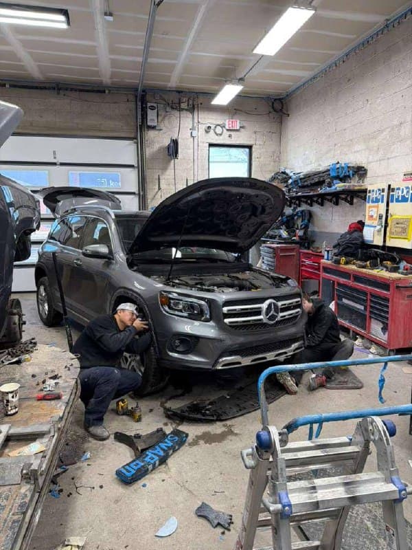 A technician working on a Mercedes in the shop